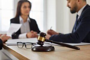 Close,up,of,a,judge’s,gavel,and,glasses,on,a