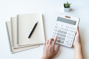 Businesswoman,using,a,white,calculator,to,calculate,the,value,of