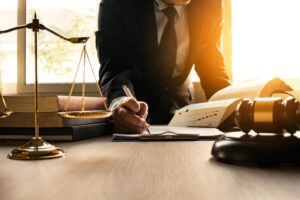 Male,lawyer,working,with,contract,papers,and,wooden,gavel,on
