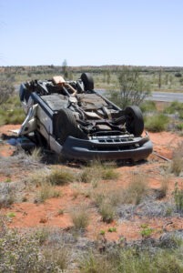 a car is upside down in the desert after a rollover accident
