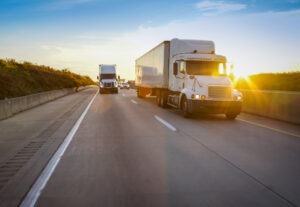 Two 18 wheelers drive on fort worth road in texas