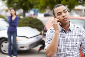 Man on phone at car accident scene in roswell