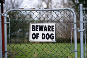 A beware of dog sign on a porch. A Tempe dog bite lawyer can help you after an attack.