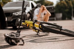 Bicycle,and,helmet,on,road,and,driver,near,car