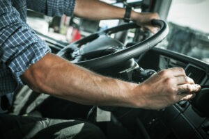 Person in driver seat of truck