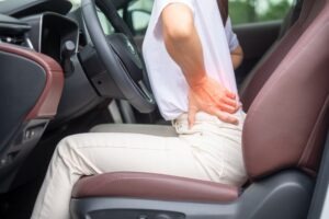 Person with hand on back in driver’s seat