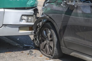 Close up of bus and car fender bender